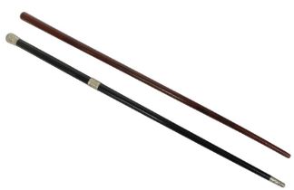 Two early 20th century conductor's batons, one ebony and white metal and one mahogany