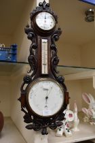 Late 19th century carved oak wall barometer and 8 day clock combined by Schwerer of Truro