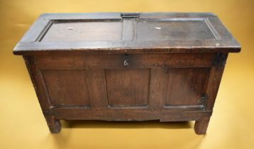 A mid 17th century English oak coffer with original locks and hinges, three panelled front, two to