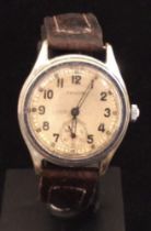 A WW2 era Timor military wristwatch, broad arrow marked to the case cover, plus A.T.P (Army Trade