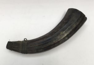 Large 19th century powder horn, with metal mounts and hanging rings. Of curved form with natural