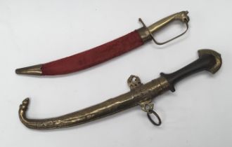 An early 20th century Middle Eastern Khanjar dagger. Wooden grip with chased brass pommel, and a