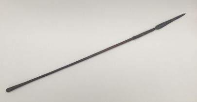 A 19th century South African throwing spear, possibly a Zulu Iklwa. Polished wooden shaft with