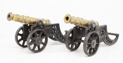 A pair of well made late 19th century bronze and cast iron signalling canons. Bronze barrels, with