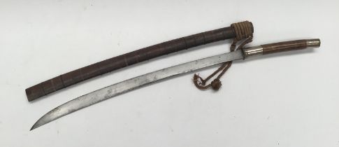 A 19th century Burmese Sword (Dha). Rounded wooden grip with white metal pommel and guard. Steel