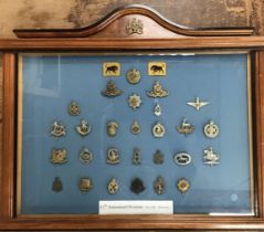 Large framed cap badge collection of the 11th Armoured Division 1941-1956, within a good quality