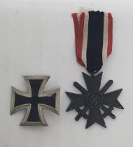 A WW2 era German Iron Cross 1st class marked L/11 for Wilhelm Deumer Ludenscheid. Painted iron core,