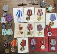 Collection of Russian medals from post 1945 to Cold War period with reproduction orders and badges.