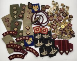 A large selection of WW2 and Post WW2 era R.A.M.C related metal badges, cloth formation patches,