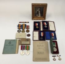A selection of WW1 and WW2 medals ephemera. To include: a WW1 medal pair, fibre dog tag, and later