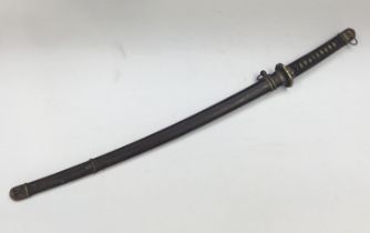 A WW2 era Japanese Katana sword. Shagreen handle with leather wrap, bronze mounts and tsuba.