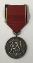 A WW2 era German Anschluss Medal, with ribbon and pin-back clasp. Issued to commemorate the