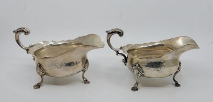 A pair of silver sauce boats, by C S Harris & Sons Ltd, London 1906, having flying scroll handle