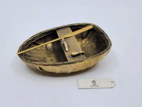 A silver-gilt model of a coracle, by Garrard & Co, London 1957, the marks also including crowned