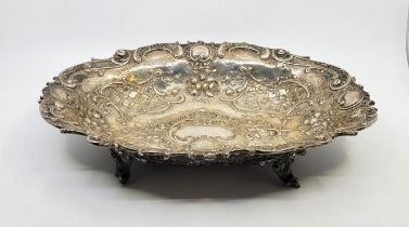 An Austro-Hungarian oval silver bowl, maker "A.St", repousse scrolls and flowers, raised upon four