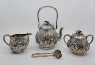 A Japanese three piece silver tea service, Meiji period, of fine quality, comprising swing handled
