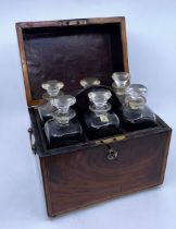 A 19th century wooden cased decanter box, having twin brass carry handles raised upon four brass