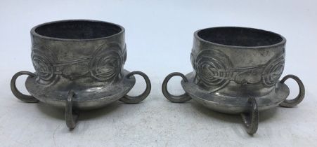 A pair of Liberty & Co. Tudric pewter vases designed by Archibald Knox, model No.0288, of