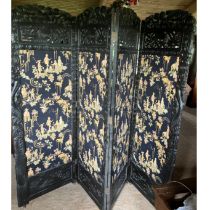 Four panelled orientally themed screen on castors heavily carved frame comprising of four 186 x 64cm