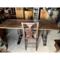 An oak refectory table on carved baluster legs plus four rush seated chairs (in need of re-reeding)