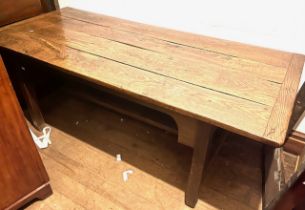 A George III oak and elm farmhouse table, four plank top with cleated ends, raised on square
