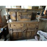 20th c Oak buffet, centre cupboard with twin baluster supports over a two drawer, two cupboard