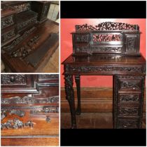 Small carved ebonised possibly mahogany desk with single pedestal and two supporting carved legs,