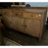 Oak sideboard 3 drawers over three cupboards one double.  Tapered short legs 95cms H x 50cms D x
