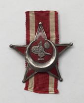 A WW1 era, German made Gallipoli Star by B.B & Co of Berlin. Brass star with red enamel infill,
