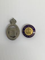 2 WW1 home front badges. To include: a 1915 ‘On War Service’ oval badge, with button hole fitting to