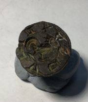 Medieval copper alloy seal matrix, hexagonally faceted handle with a pierced terminal. Circular,