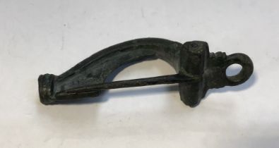 Roman bronze decorated “bow” fibula brooch with pin intact. Approximately 6.5cm.