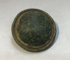 2nd century copper alloy Roman circular plate brooch. Pin is still present but bent. Gold gilt is