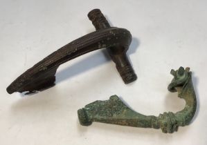 Two Roman Brooches, Decorated sprung “dolphin” Roman fibular brooch. Both spring and pin are