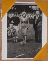 Football: An interesting black and white photograph of Marilyn Monroe kicking a football at the