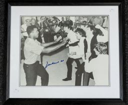 Muhammad Ali: A framed and glazed signed print of Muhammad Ali and The Beatles, signed by Muhammad