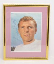 Bobby Moore: A framed and glazed printed photograph / magazine cutout of Bobby Moore, signed to