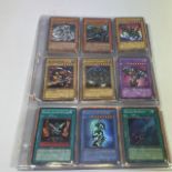 A collection of Yu Gi Oh trading card game cards 1996.  Including Blue-Eyes White Dragon 1st