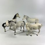 4 Beswick dapple grey horses. One with a chip to ear.