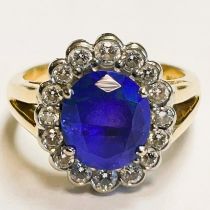 An oval tanzanite 4 claw set in 18ct yellow gold with diamonds in graduation cluster ring. Tanzanite