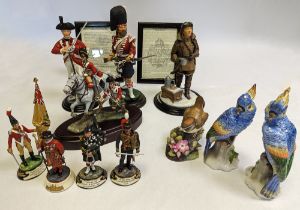 A collection of ceramic figures to include military and bird figurines. Birds include, a pair of