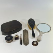 A silver back tortoiseshell hand mirror and brush other dressing table items and a silver thimble.