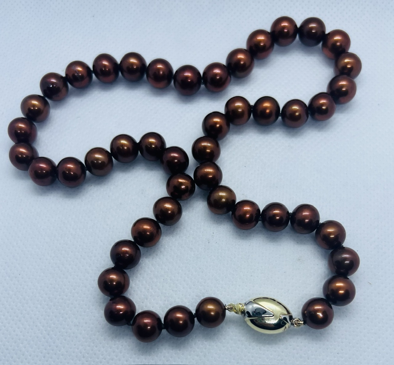******AWAY TO VENDOR****** Stylised "coffee bean" clasped Princess length brown cultured pearl