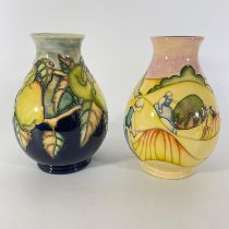 Two Moorcroft vases including trial piece. Approximately 19cm tall. Both in good condition.  Some