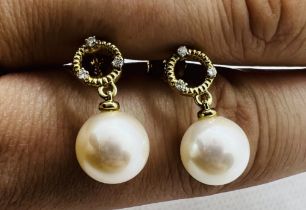 ****AWAY TO VENDOR ****** A pair of diamond and cultured pearl drop earrings. Each featuring an