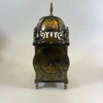 A brass lantern clock approx 29cm tall. Movement has been replaced with a quartz movement