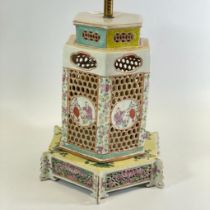 A Chinese hexagonal form reticulated lamp in two parts tapering in size. With decorated panels,