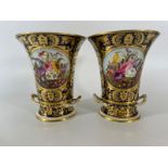 A pair of early 19th Century Derby Vase planters with foliate cartouches on a cobalt blue and gilt