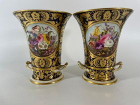 A pair of early 19th Century Derby Vase planters with foliate cartouches on a cobalt blue and gilt