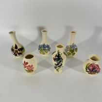 A collection of five Moorcroft white ground vases. Tallest approximately16cm. Some crazing but